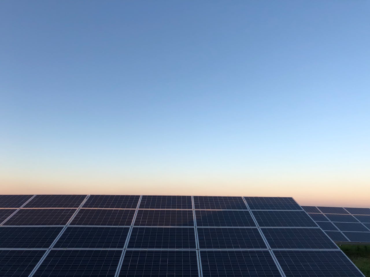 Captivating view of solar panels at sunrise highlighting renewable energy in Andria, Italy.